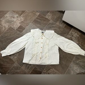 Kina and Tam white ruffled shirt
